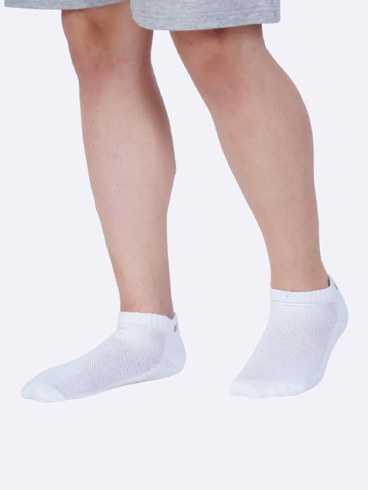 Pair of low ankle socks in a neutral color, designed to cover the foot and ankle for comfort and breathability.